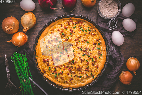 Image of Homemade onion tart or pie with bacon and chives