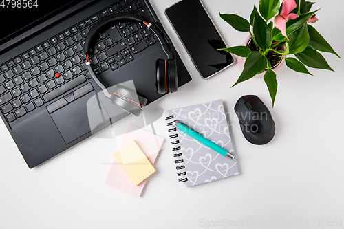 Image of Workplace and office desk with laptop, headset and smarthpone