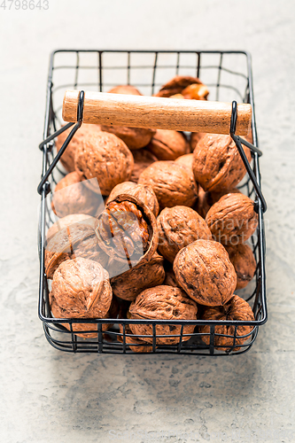 Image of Organic walnuts in basket on kitchen table