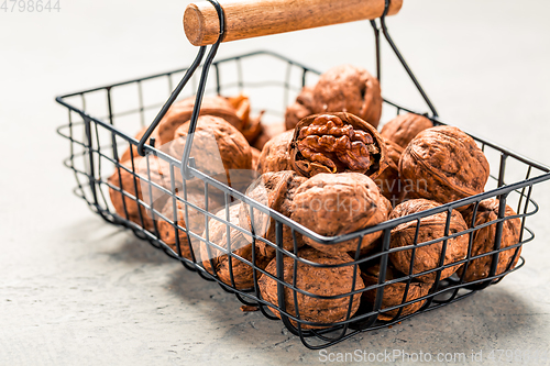 Image of Organic walnuts in basket on kitchen table