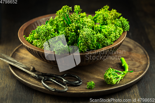 Image of Organic Broccolini (bimi) in bowl on wooden background