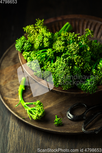 Image of Organic Broccolini (bimi) in bowl on wooden background