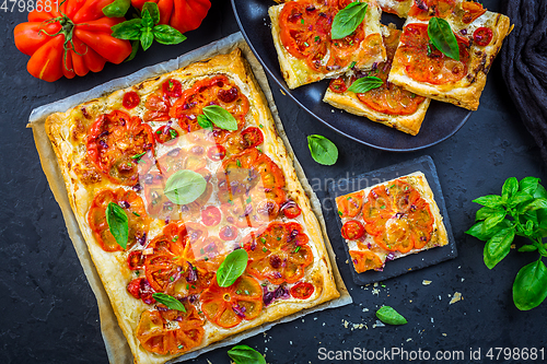 Image of Vegetarian tomato tart or puffed pizza with herbs