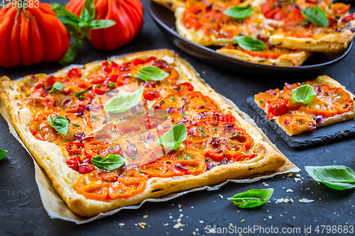 Image of Vegetarian tomato tart or puffed pizza with herbs