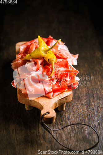 Image of Prosciutto with grilled peppers -  Italian dry ham with grilled green peppers