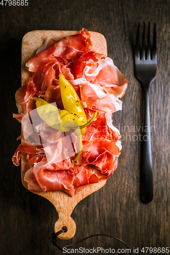 Image of Prosciutto with grilled peppers -  Italian dry ham with grilled green peppers