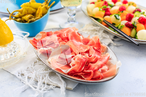 Image of Cucumber and melon salad with raspberries and Prosciutto with grilled peppers 