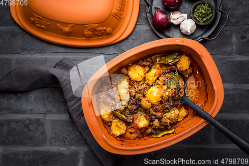 Image of Goulash with potatoes and sauerkraut. Beef and vegetable stew in clay pot