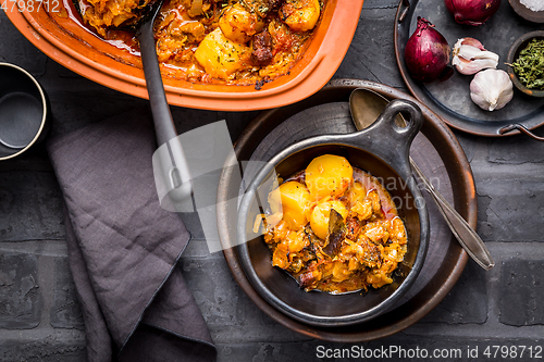 Image of Goulash with potatoes and sauerkraut. Beef and vegetable stew in clay pot