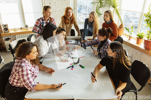 Image of Young people discussing about women rights and equality at the office