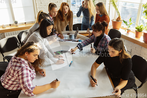 Image of Young people discussing about women rights and equality at the office