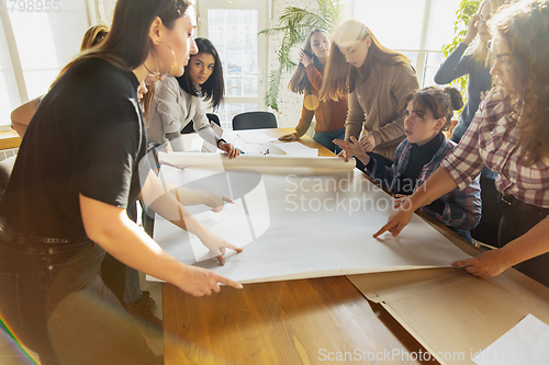 Image of Young people discussing about women rights and equality at the office