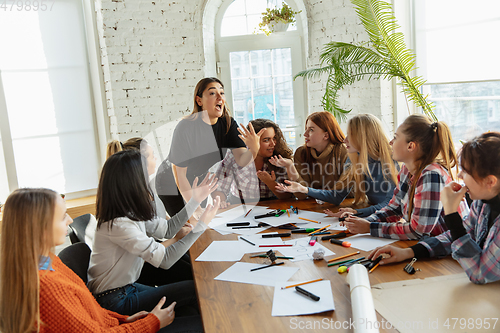 Image of Young people discussing about women rights and equality at the office