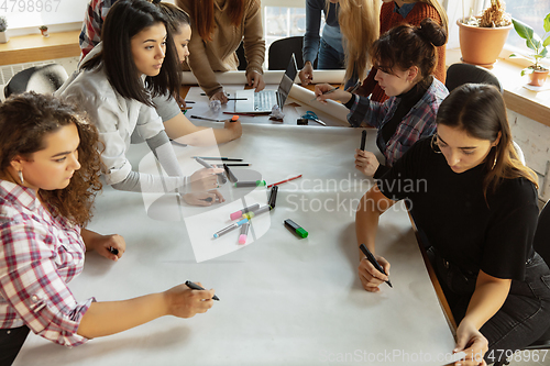 Image of Young people discussing about women rights and equality at the office