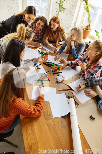 Image of Young people discussing about women rights and equality at the office