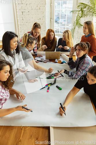 Image of Young people discussing about women rights and equality at the office