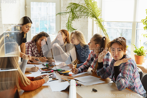 Image of Young people discussing about women rights and equality at the office