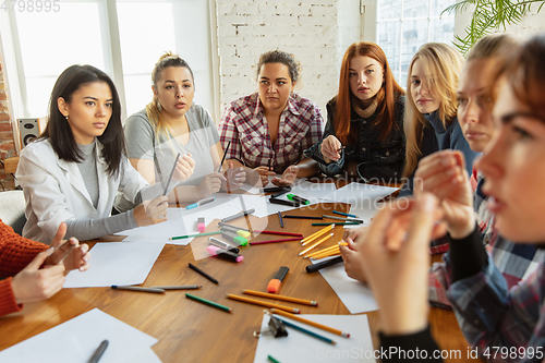 Image of Young people discussing about women rights and equality at the office