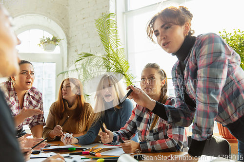 Image of Young people discussing about women rights and equality at the office