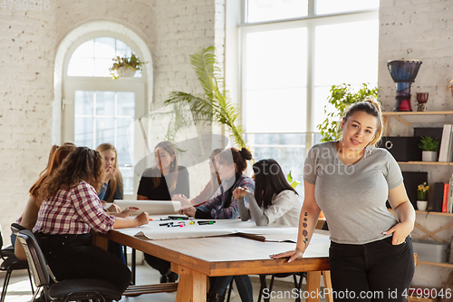 Image of Young people discussing about women rights and equality at the office