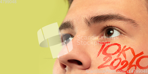 Image of Caucasian young man\'s close up portrait on bright background, Tokyo 2020