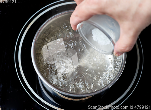 Image of salt is added to boiling water