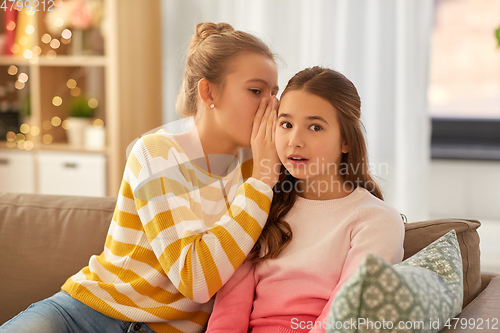 Image of teenage girls gossiping at home