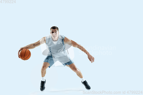 Image of Young caucasian basketball player against white studio background