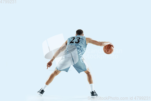 Image of Young caucasian basketball player against white studio background