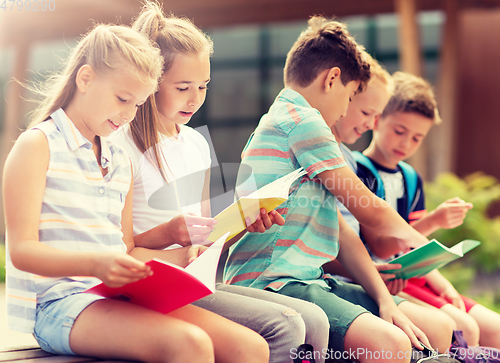 Image of group of happy elementary school students outdoors