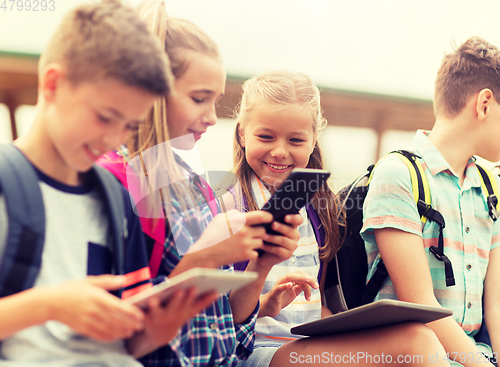 Image of group of happy elementary school students talking