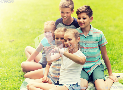 Image of happy kids or friends taking selfie in summer park