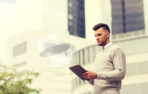 Image of man with tablet pc computer in city