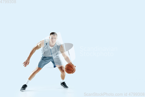 Image of Young caucasian basketball player against white studio background