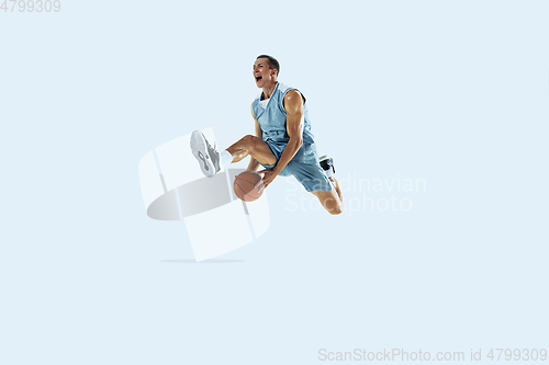 Image of Young caucasian basketball player against white studio background