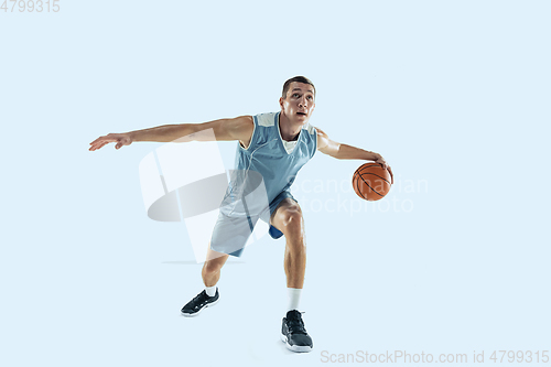 Image of Young caucasian basketball player against white studio background