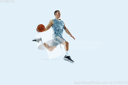 Image of Young caucasian basketball player against white studio background