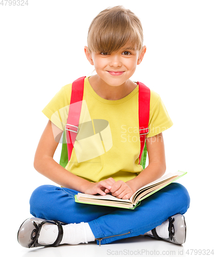 Image of Portrait of a cute little schoolgirl with backpack