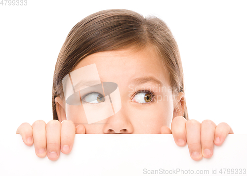 Image of Little girl is looking from out blank board