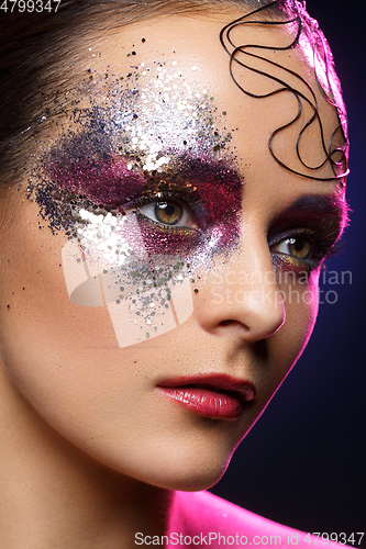 Image of beautiful woman with bright makeup with glitter