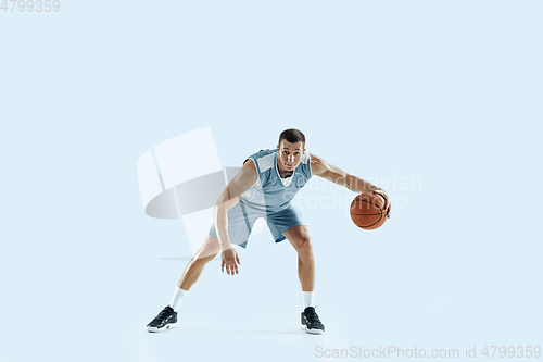 Image of Young caucasian basketball player against white studio background