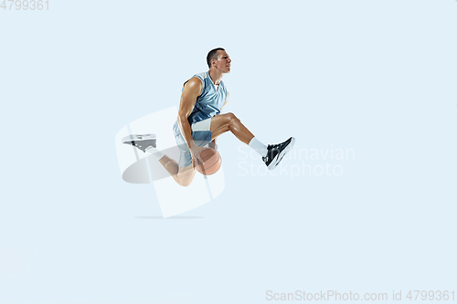 Image of Young caucasian basketball player against white studio background