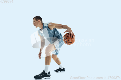 Image of Young caucasian basketball player against white studio background