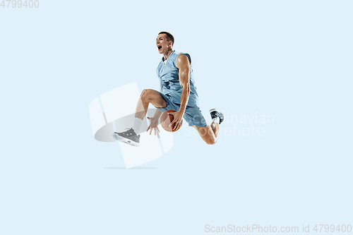 Image of Young caucasian basketball player against white studio background