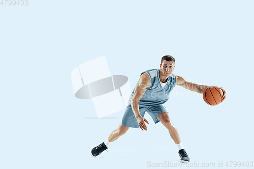 Image of Young caucasian basketball player against white studio background