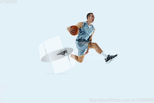 Image of Young caucasian basketball player against white studio background