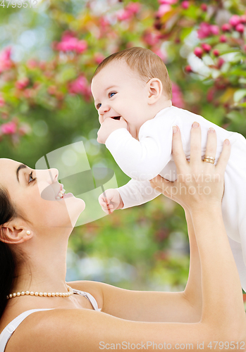 Image of mother with baby over spring garden background