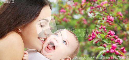 Image of mother with baby over spring garden background