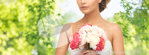 Image of young woman or bride with bouquet of flowers