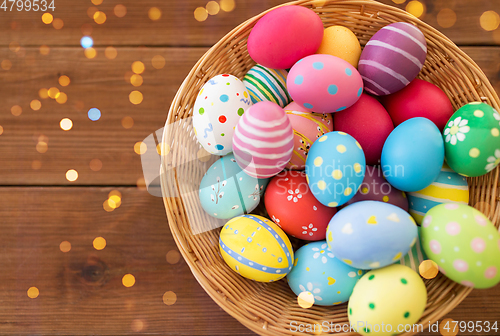 Image of close up of colored easter eggs in basket